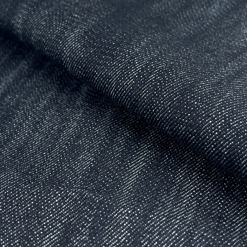 Closeup of a medium weight, 12 ounce per square yard denim with medium indigo yard-dye hue. 