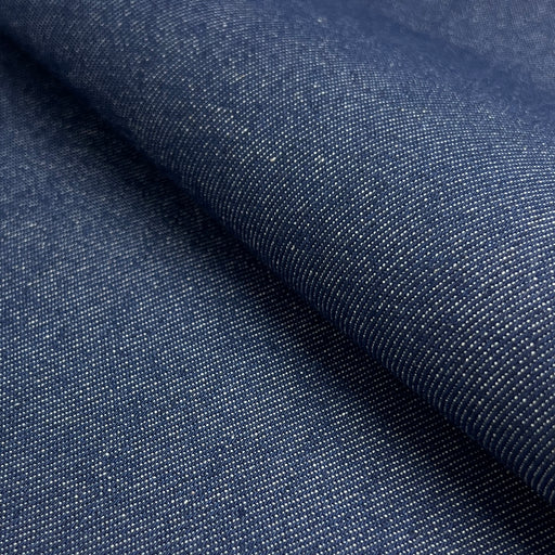 Close-up of dark blue denim fabric with visible texture