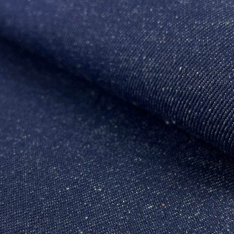 Close-up of dark blue denim fabric with visible texture