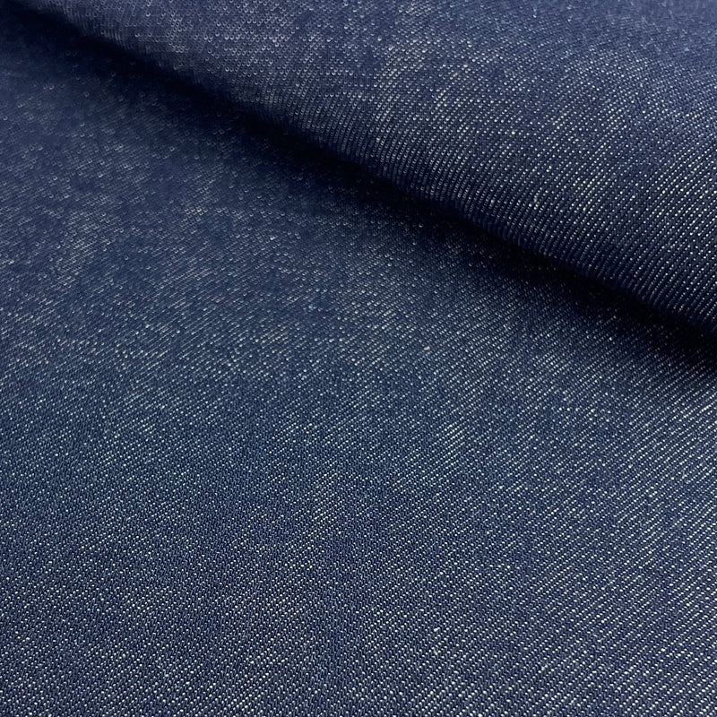 Close-up of blue denim fabric with a subtle pattern