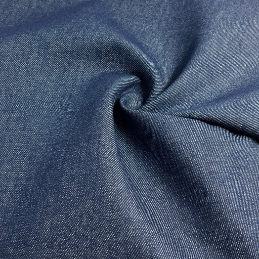 Close-up of blue denim fabric with a visible texture