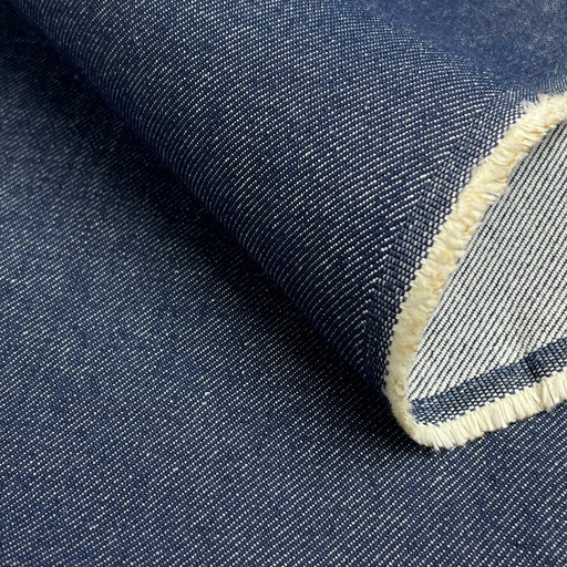 Close-up of denim fabric with a visible seam