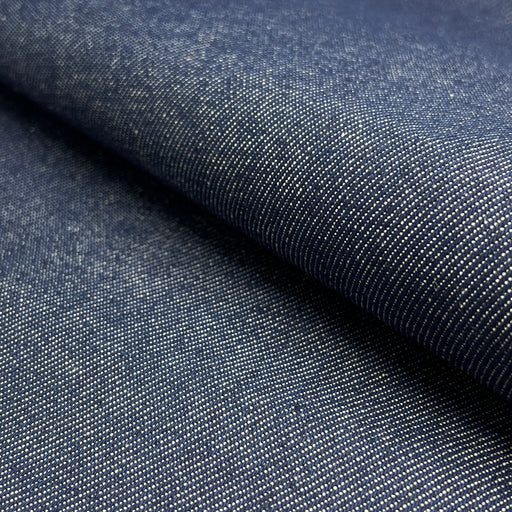 Close-up of dark blue denim fabric with a subtle pattern