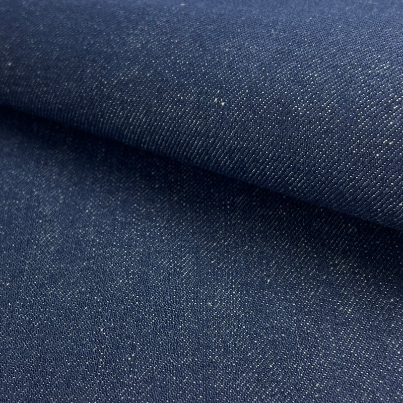 Close-up of dark blue denim fabric with a subtle pattern