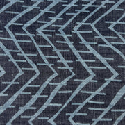 Close-up of a lightweight tencel denim with a geometric pattern on a dark indigo background