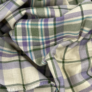 Close-up of plaid fabric with purple, green, and white colors.