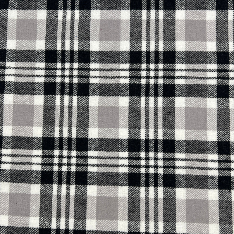 Lightweight cotton flannel shirting fabric featuring a tartan plaid design of black, white & taupe.