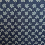 Pattern of clover leaves on a blue fabric background
