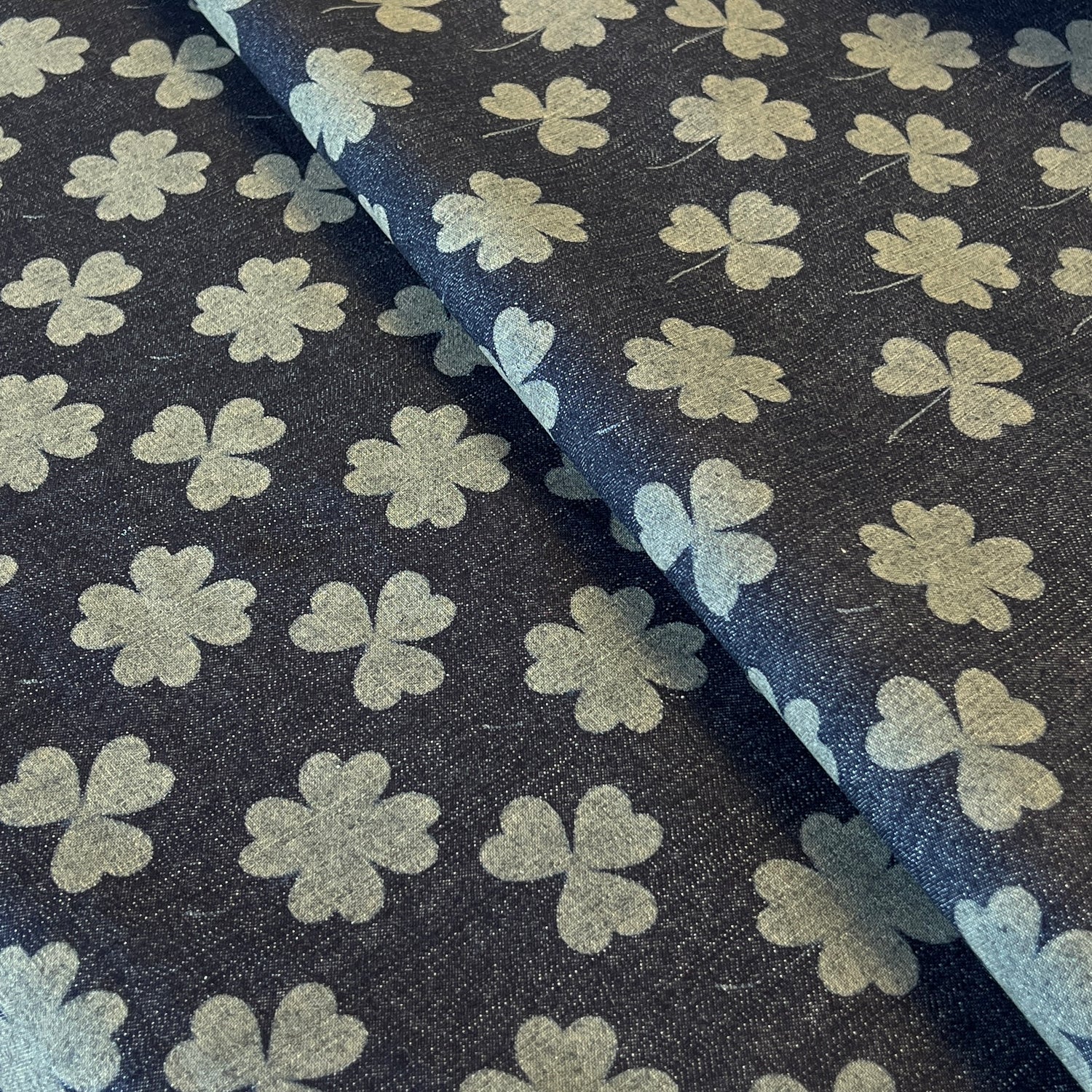 Fabric with clover leaf pattern on a dark background