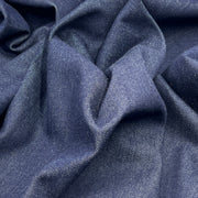 Close-up of blue denim fabric with folds
