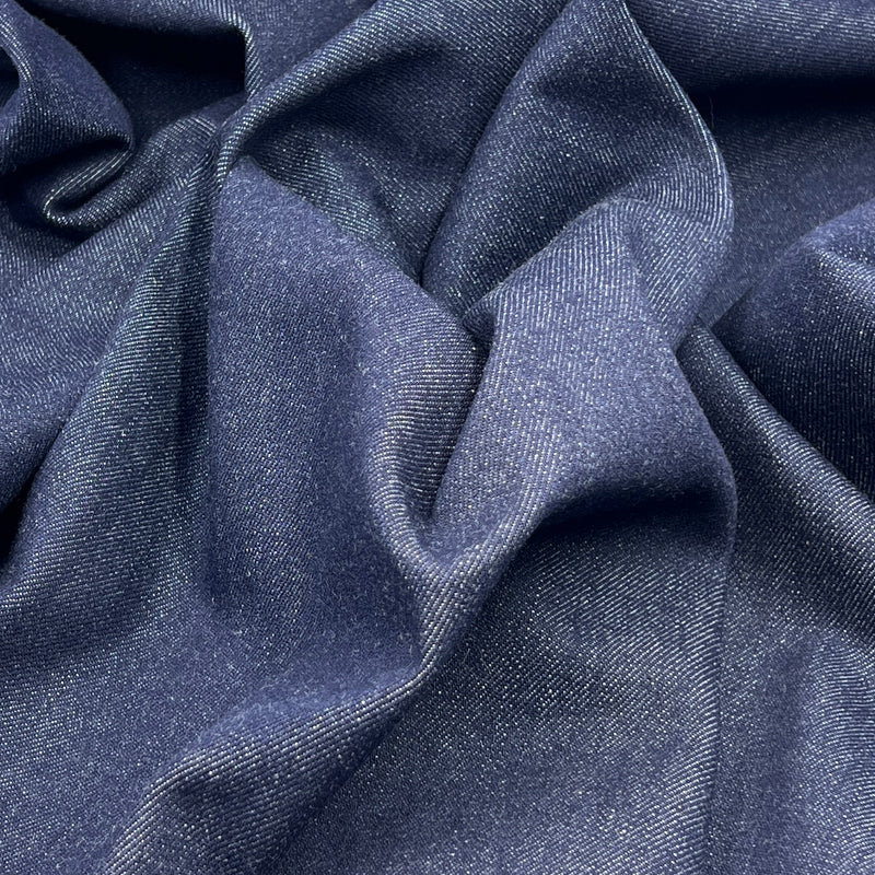 Close-up of blue denim fabric with folds