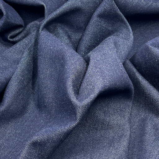 Close-up of blue denim fabric with folds