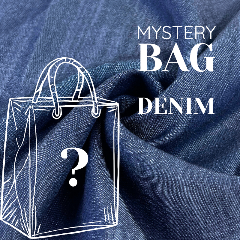 Denim fabric with a transparent bag outline and question mark, labeled 'Mystery Bag Denim'.