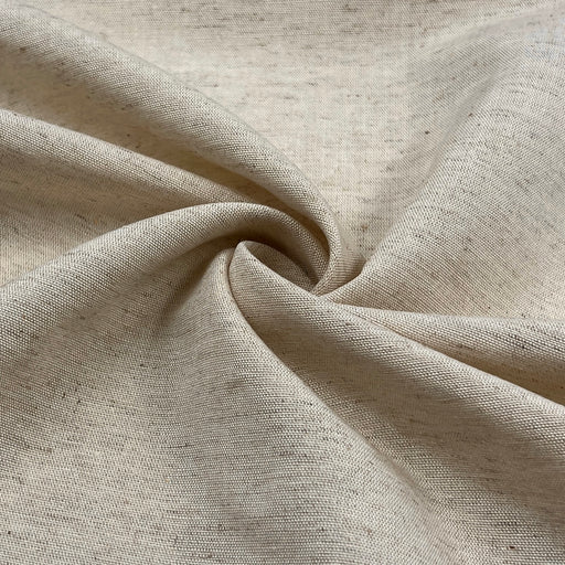 Close-up of beige linen fabric with a textured natural seeded surface