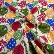 Colorful patterned fabric with various shapes and designs on a beige background