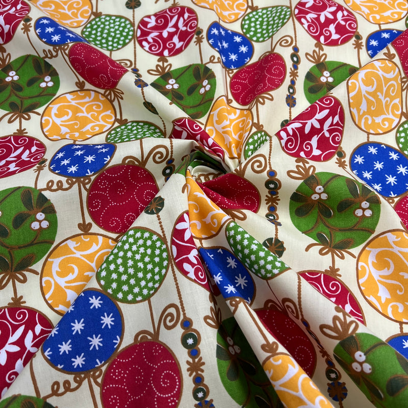 Colorful patterned fabric with various shapes and designs on a beige background