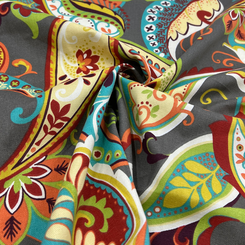 Colorful paisley pattern fabric with intricate designs on a gray background