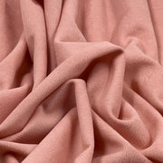 Close-up of pink suede-like moleskin fabric with soft brushed surface and dusty pink coloring