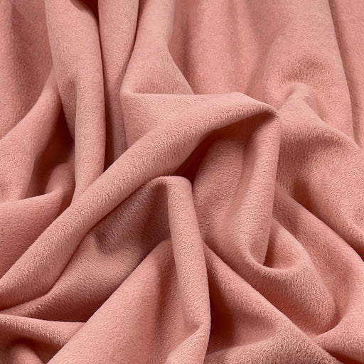 Close-up of pink suede-like moleskin fabric with soft brushed surface and dusty pink coloring