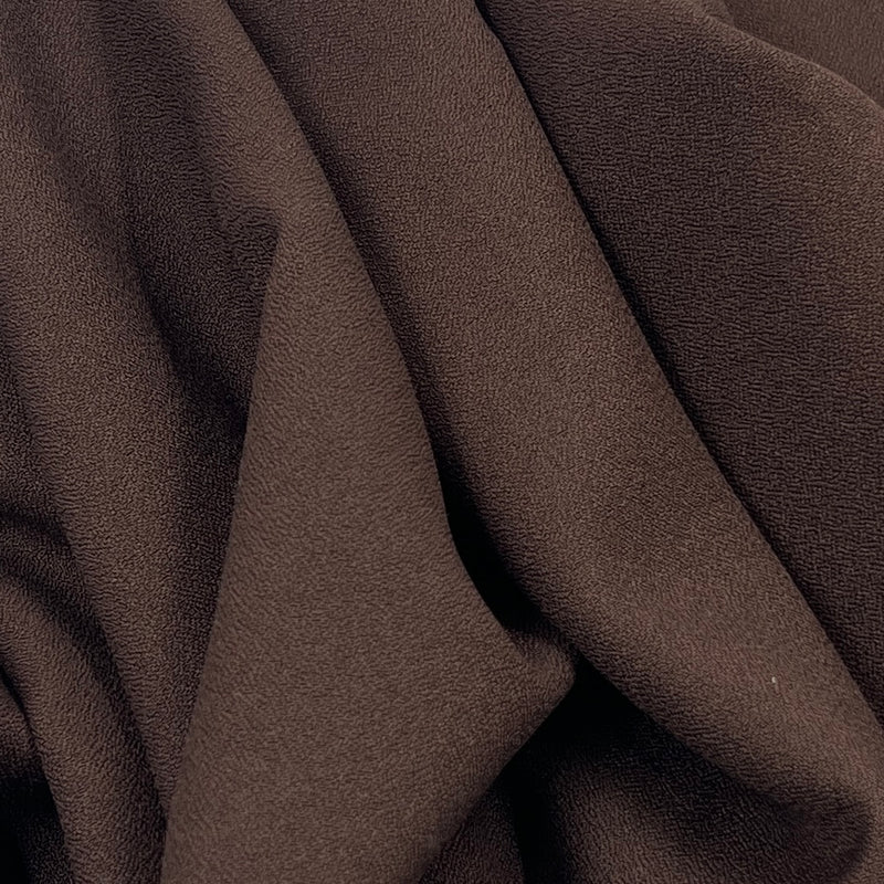 Close-up of brown fabric with folds