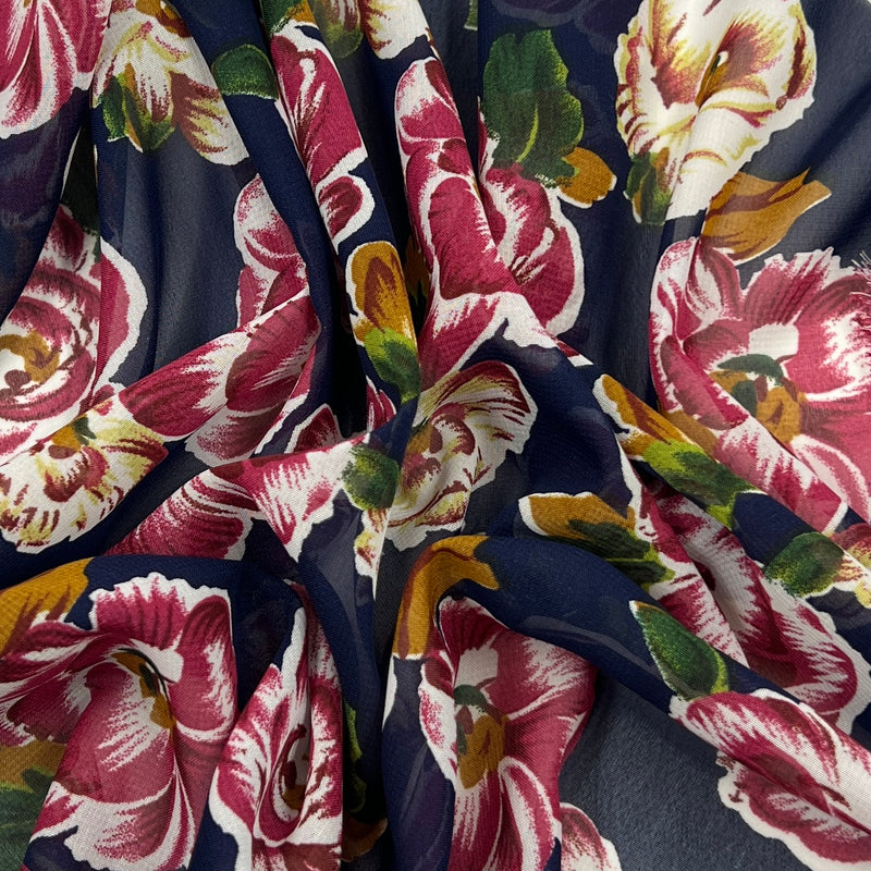 Close-up of floral fabric with pink and green flowers on a dark background