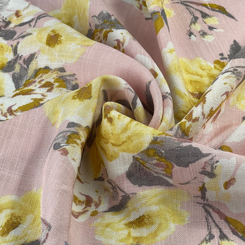 Close-up of floral rayon faux-linen fabric with yellow flowers on a pink background