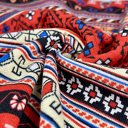 Close-up of patterned fabric with red, blue, and black colors.