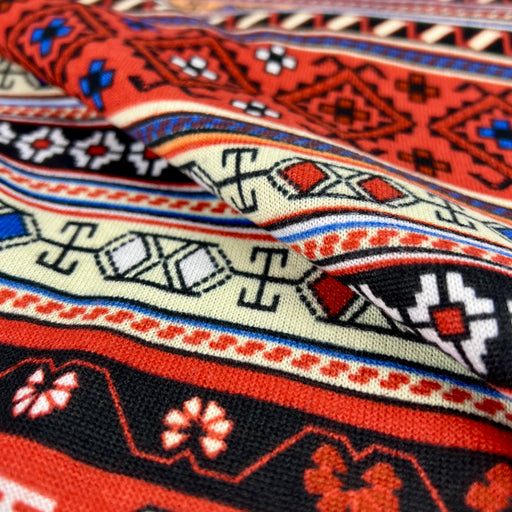 Close-up of a colorful patterned fabric with intricate designs.