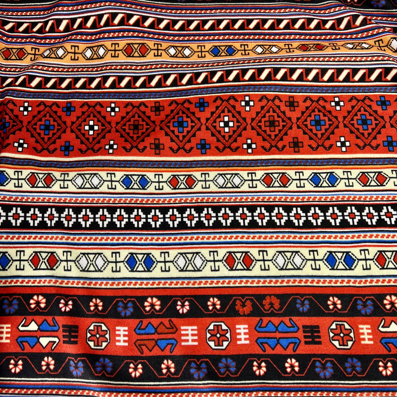 Patterned fabric with tribal design in red, blue, and beige on a white background