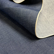 Close-up of denim fabric with a visible closed selvedge edge