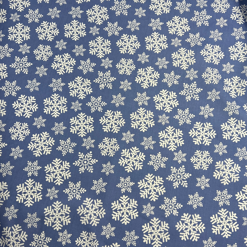 Pattern of white snowflakes on a blue background