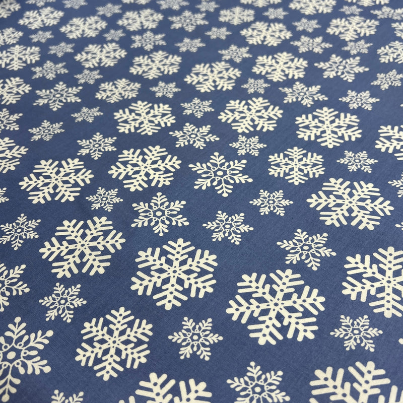 Pattern of white snowflakes on a blue background
