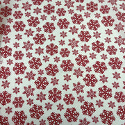 Pattern of red snowflakes on a beige background