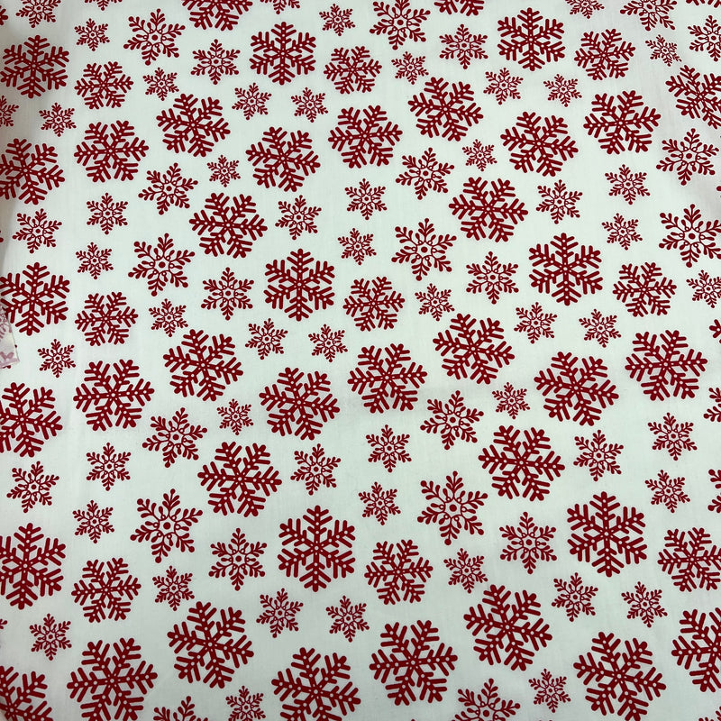 Pattern of red snowflakes on a beige background