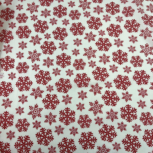 Pattern of red snowflakes on a beige background