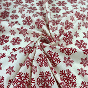 Red snowflake pattern on white fabric