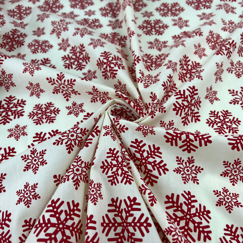 Red snowflake pattern on white fabric