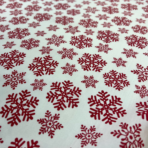 Red snowflake pattern on a white background