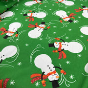 Fabric with snowman pattern on a green background