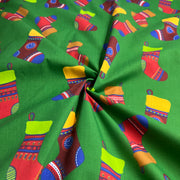 Colorful Christmas stocking pattern on green fabric