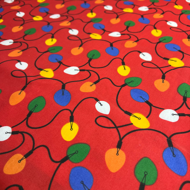 Colorful Christmas light pattern on a red background