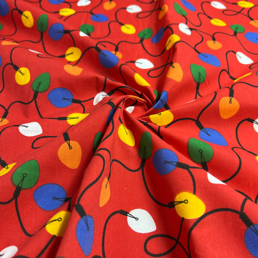 Red fabric with colorful Christmas light pattern