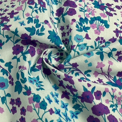 Floral fabric with purple and blue flowers on a white background
