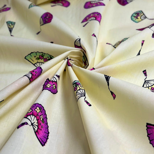 Fabric with colorful folding fan themed pattern on a beige background