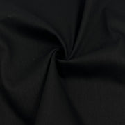 A close-up of black fabric with a gathered swirl in the center, showing the material texture and drape.