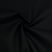 A close-up of black fabric with a subtle woven texture, arranged in a spiral drape to show its smoothness and color.