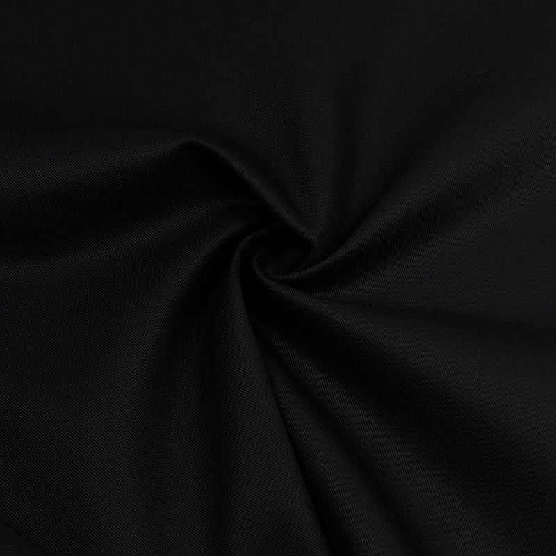 A close-up of black fabric with a subtle woven texture, arranged in a spiral drape to show its smoothness and color.