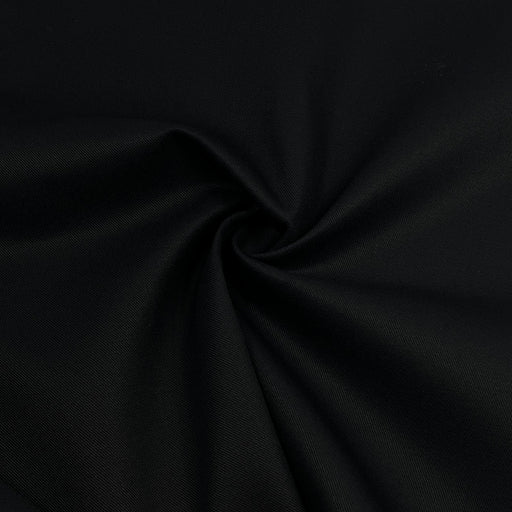 A close-up of black fabric with a subtle woven texture, arranged in a spiral drape to show its smoothness and color.