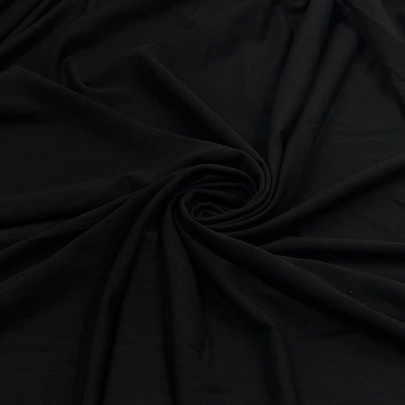 Black soft rayon and lycra jersey pulled into a swirl showing off smooth drape and texture. 