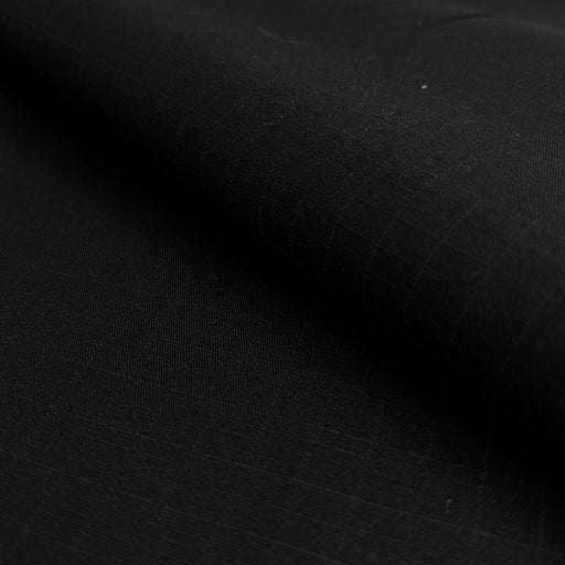 Closeup of black cotton canvas with 1/2 inch ripstop enforcement grid.